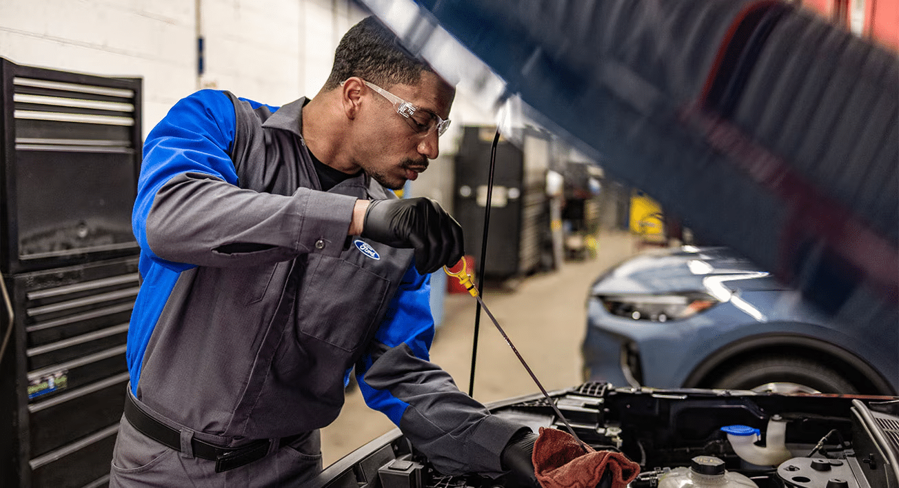 A Ford technician working on a vehicle.