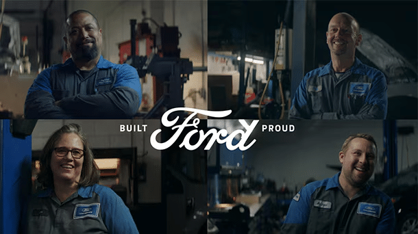 Four Ford auto workers in blue uniforms