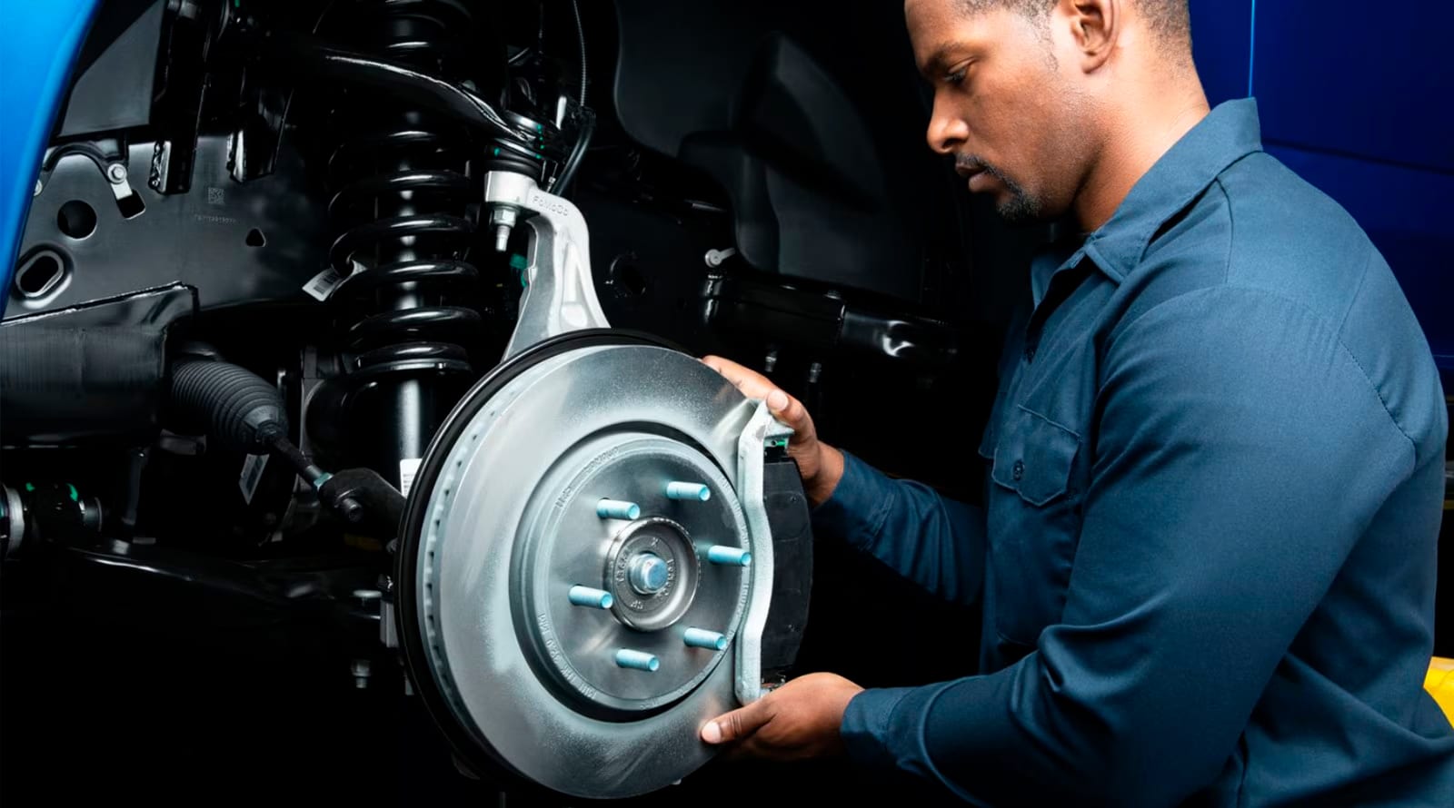 Man servicing a Ford vehicle