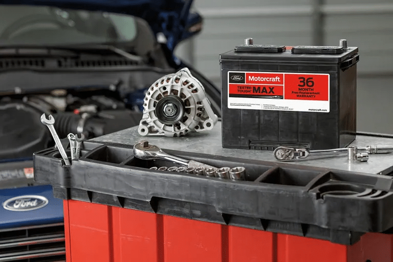 A Motorcraft battery sits atop a tool chest.