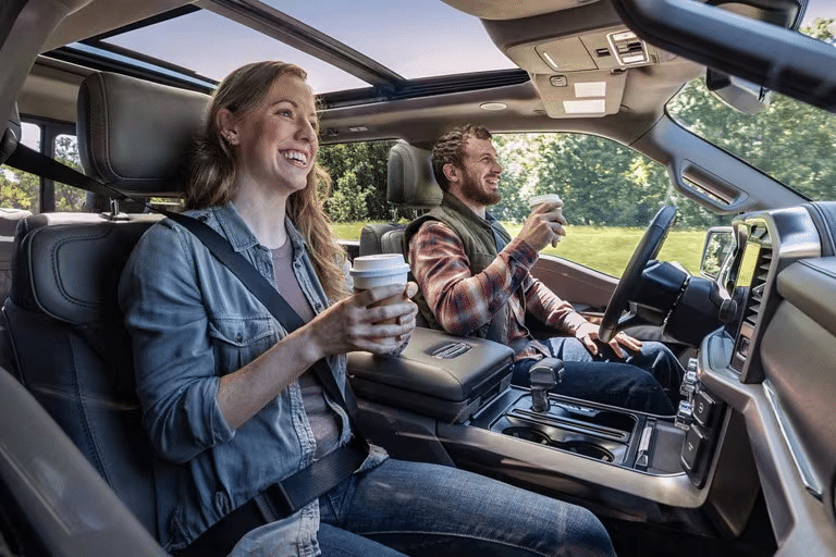A man and woman ride hands-free on the highway. 