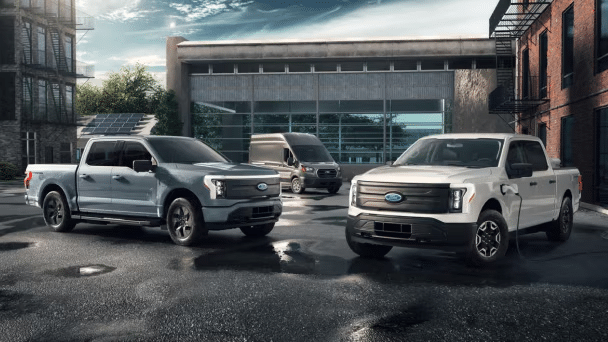 Three zero-emissions vehicles parked on a job site"