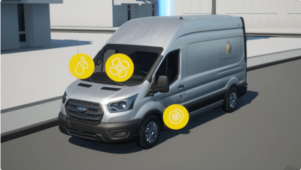 A 2023 Ford E-Transit van being driven down a road.
